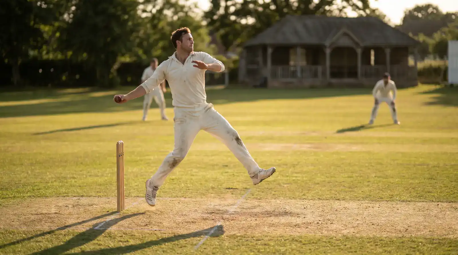 Spin bowler in mid-action delivering a leg-spinner during a County Championship afternoon session