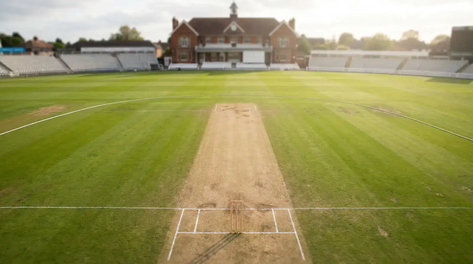 Cricket pitch from an elevated vantage with stumps at both ends and field markings