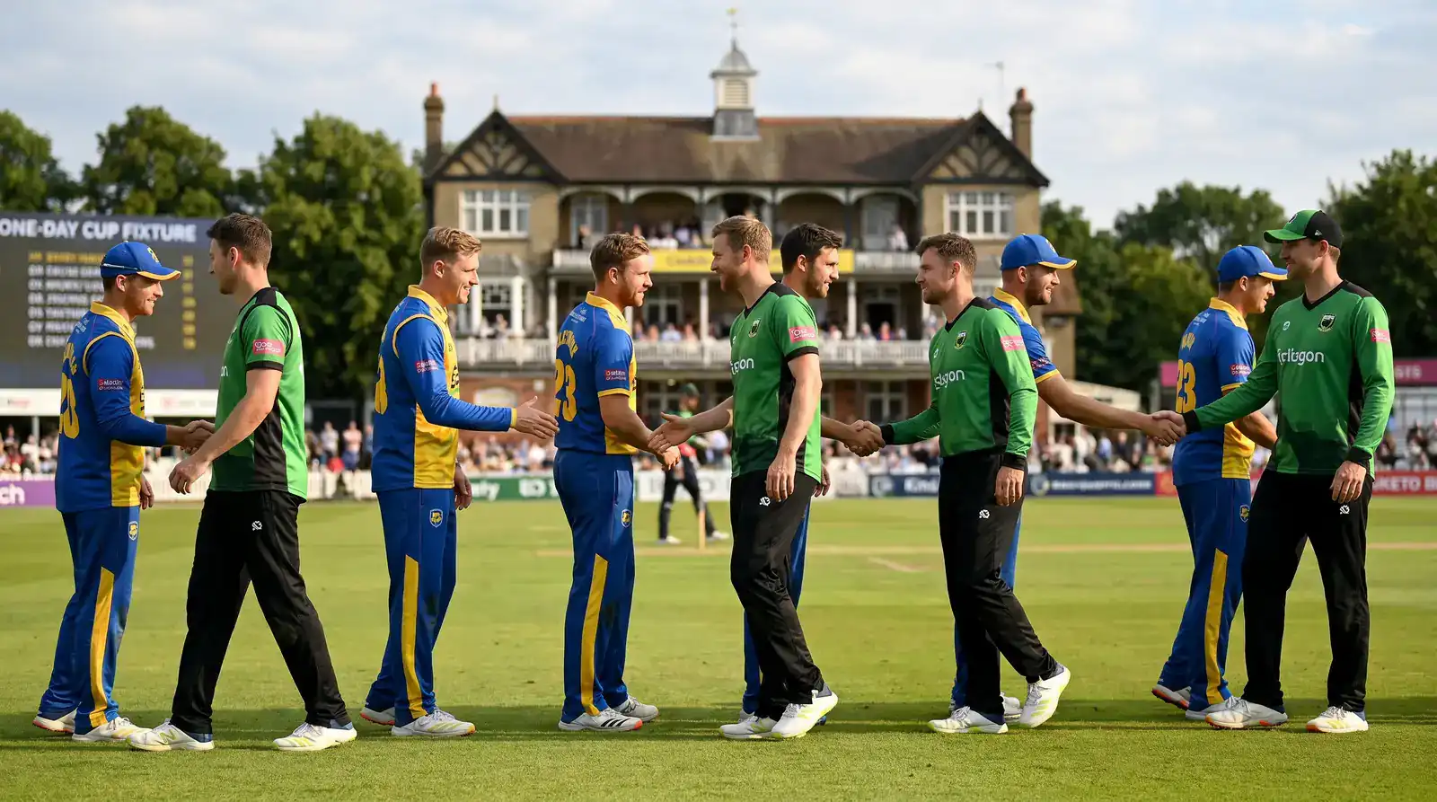 Two opposing county cricket teams lined up shaking hands at the boundary before the start of a One-Day Cup fixture
