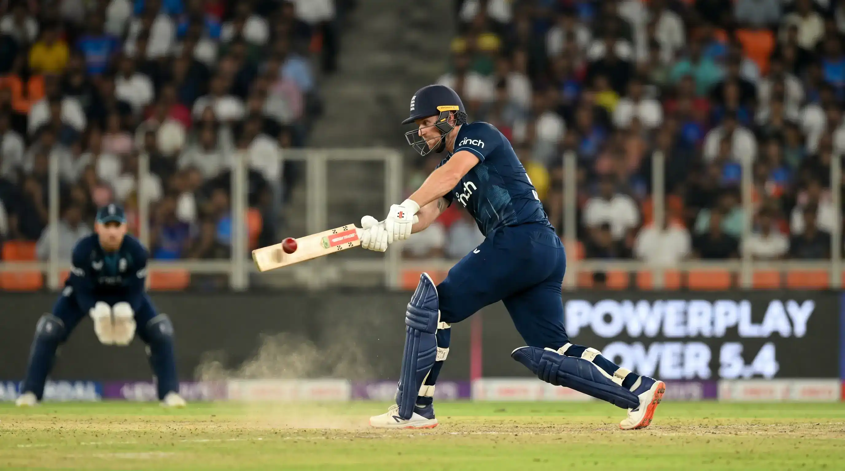 T20 powerplay close shot of a batter playing an aggressive pull shot toward midwicket against a fast bowler