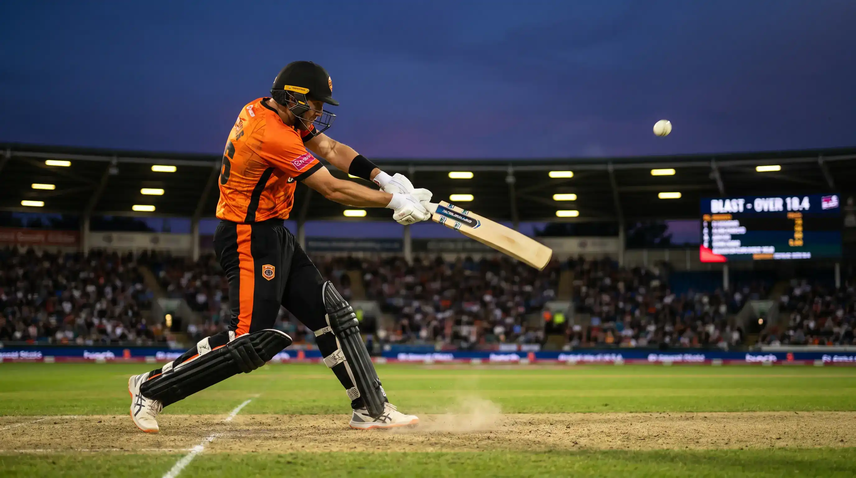 T20 Blast group stage match in progress under floodlights with a batter playing a powerful drive over the infield