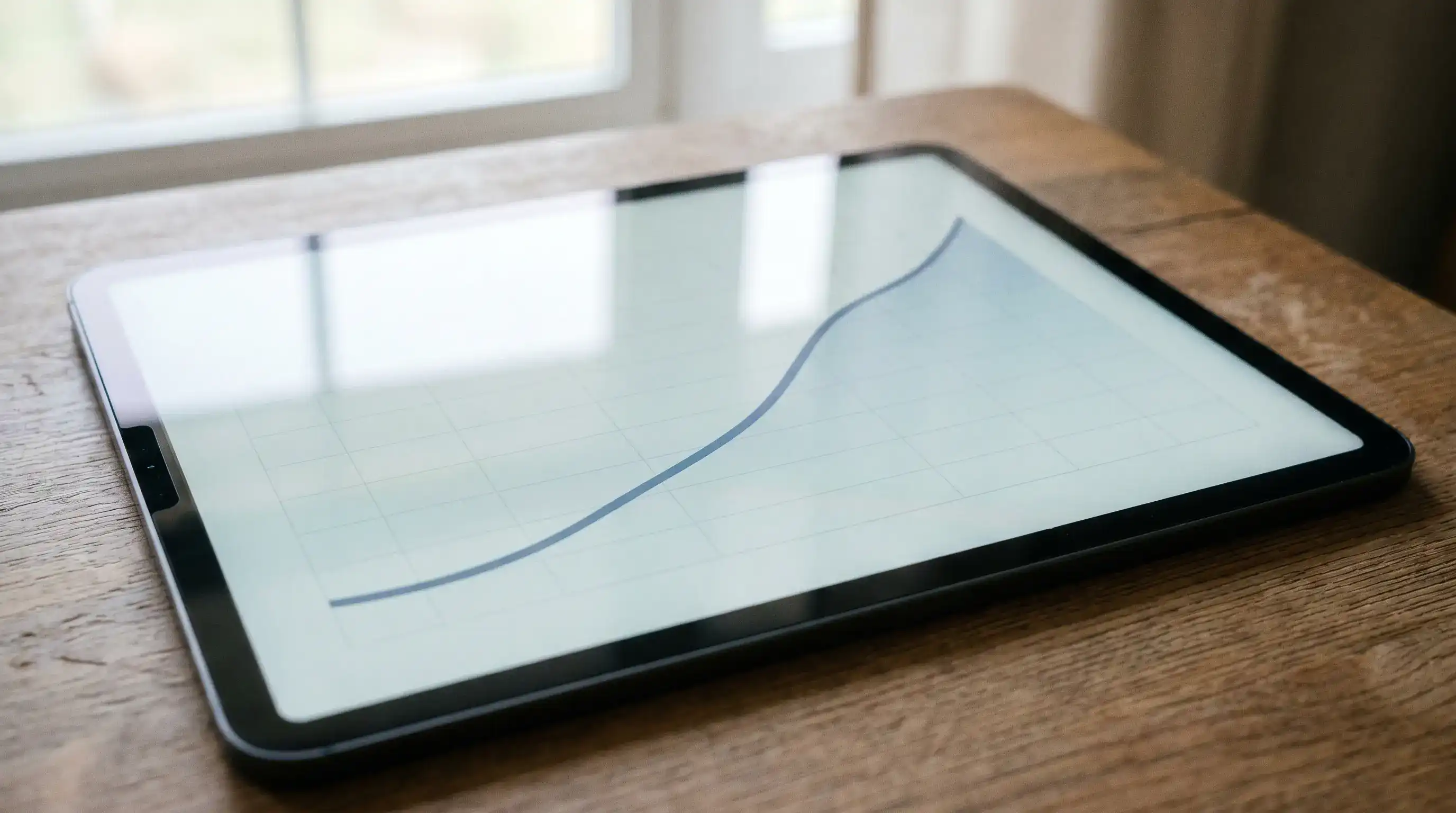 Cricket worm line chart on a tablet showing the cumulative run curve rising through the innings